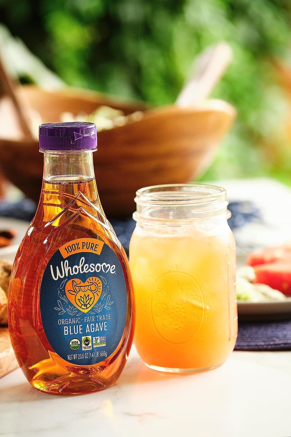 Wholesome Blue Agave Nectar beside a glass of tea for natural sweetness.