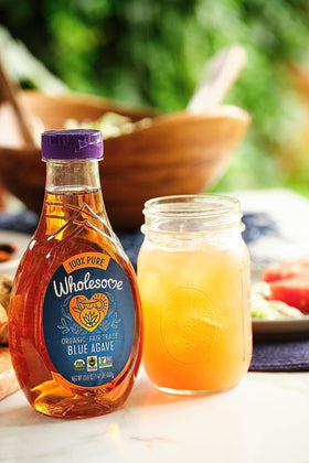 Wholesome Blue Agave Nectar beside a glass of tea for natural sweetness.