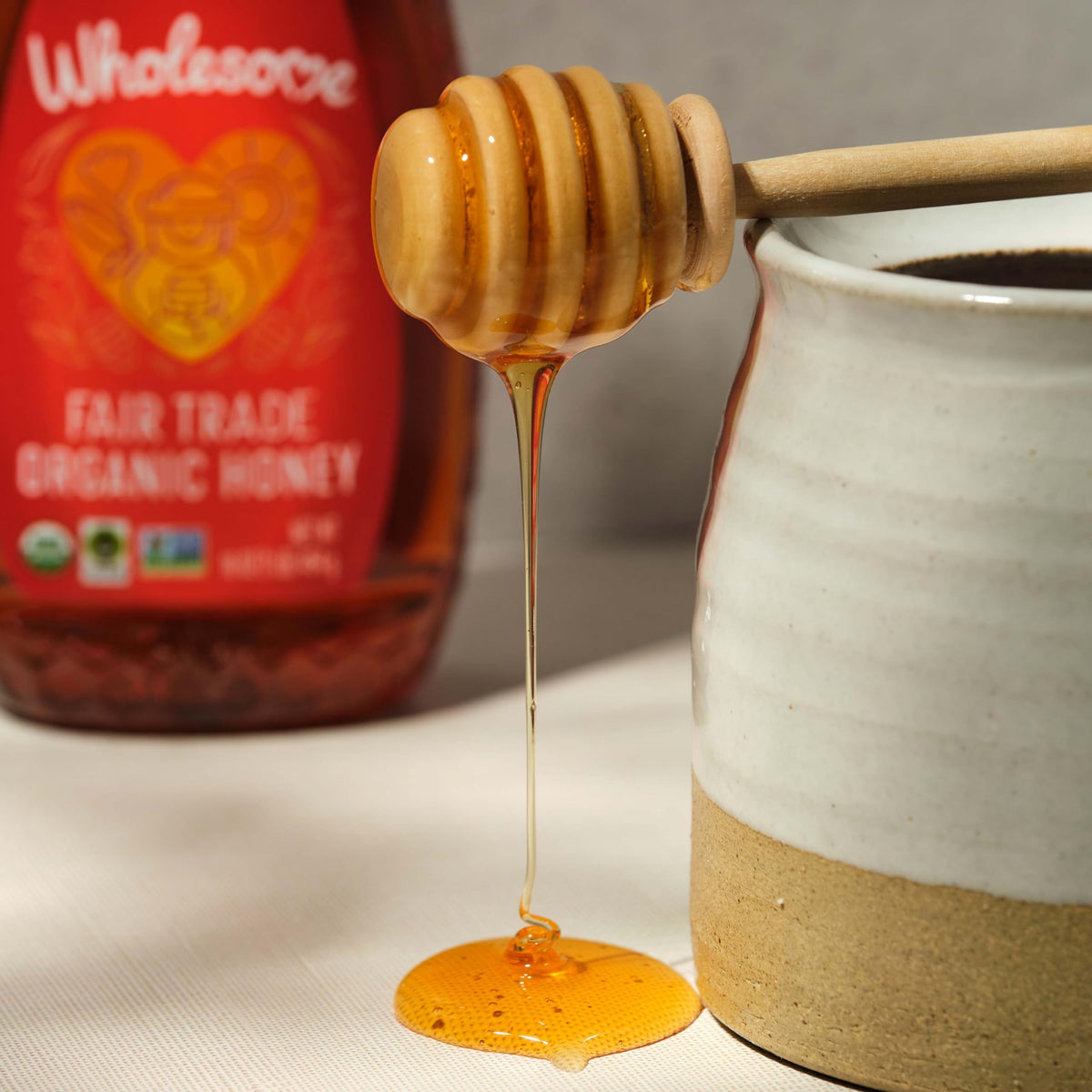 Wholesome Organic Honey close-up reveals amber color and thick, silky texture