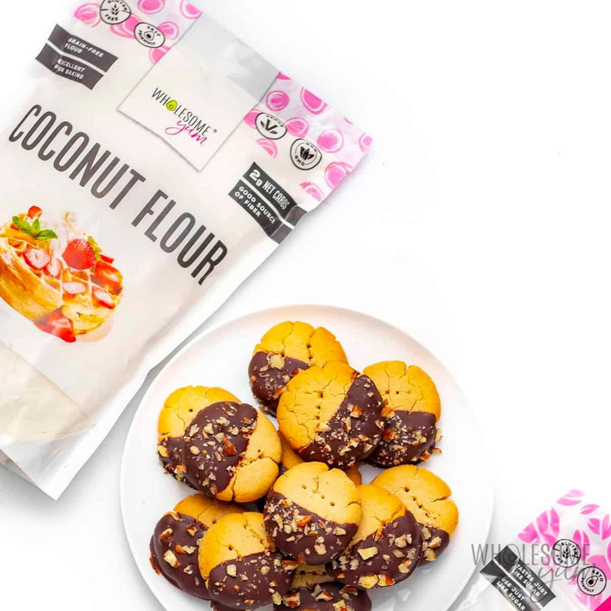 Wholesome Yum coconut flour baking-setup displayed with measuring cups and recipe card.