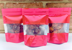 Wicked Tickle Ghost Pepper pods close-up, glossy and intensely fruity heat ready for sauces.