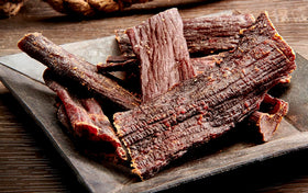 Wild Bill's Hickory Smoked Beef Jerky Strips slices close up, tender top round baked in smoke