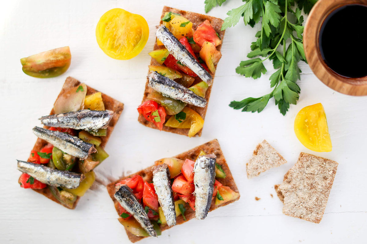 Wild Planet anchovies on tapas plate show quick, versatile serving ideas.