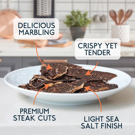 Wild Society Caveman Eats thin-sliced ribeye crisps shown in close-up, crisp texture