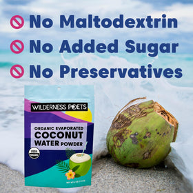 Wilderness Poets coconut water powder being poured into a glass for instant hydration