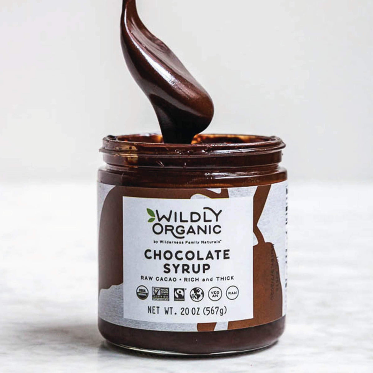 Close-up of Wildly Organic Chocolate Syrup label highlighting organic, fair trade origins.