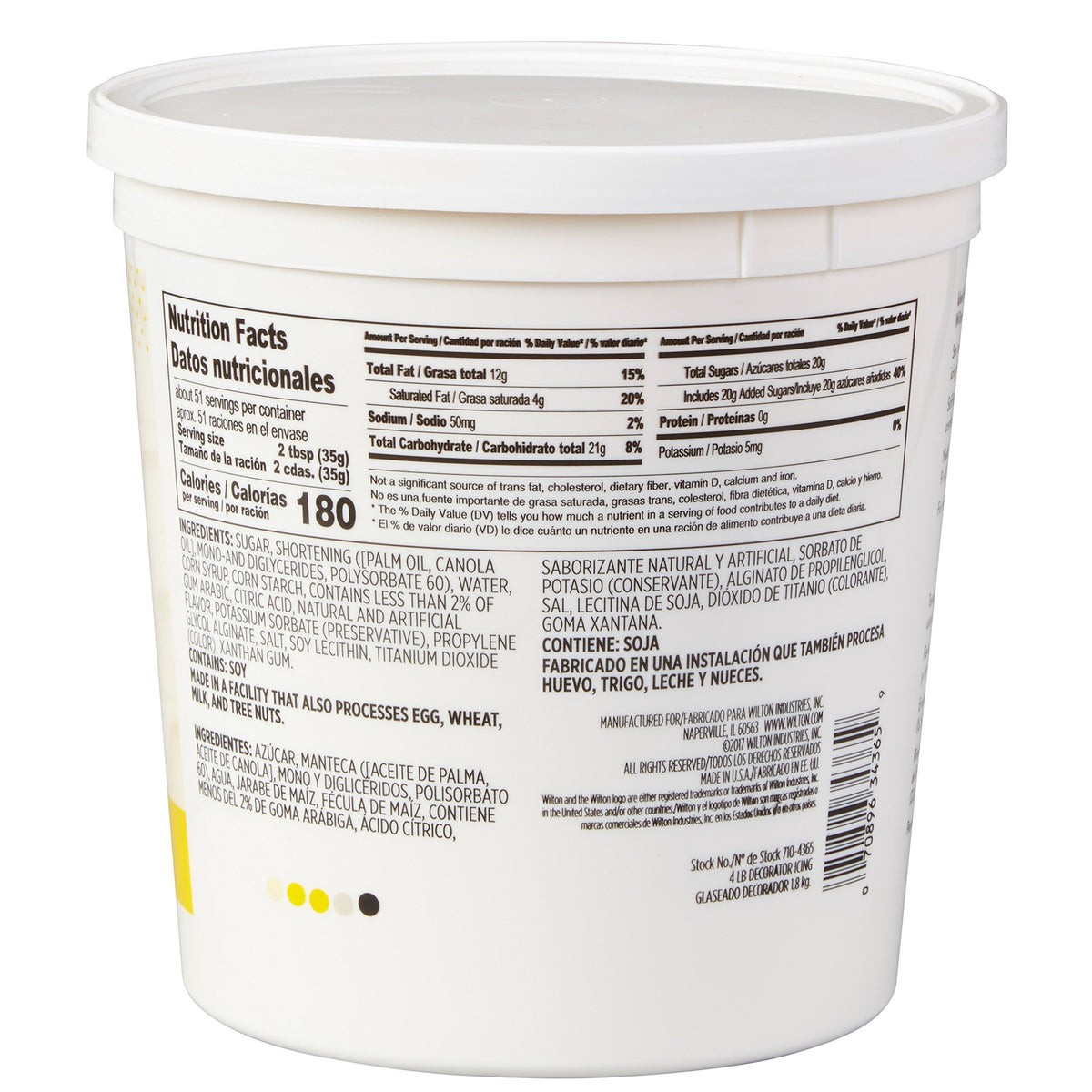 Wilton creamy white decorator icing tub being spread for even frosting.