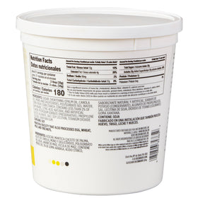 Wilton creamy white decorator icing tub being spread for even frosting.