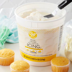 Wilton vanilla-flavored icing piping flowers and borders for cake decoration.