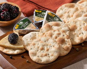 Wine Country Gift Baskets olives, crackers, and Gouda cheese spread complement the board.