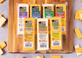 Wisconsin Cheese Company cheddar block on a charcuterie board, ideal for entertaining.