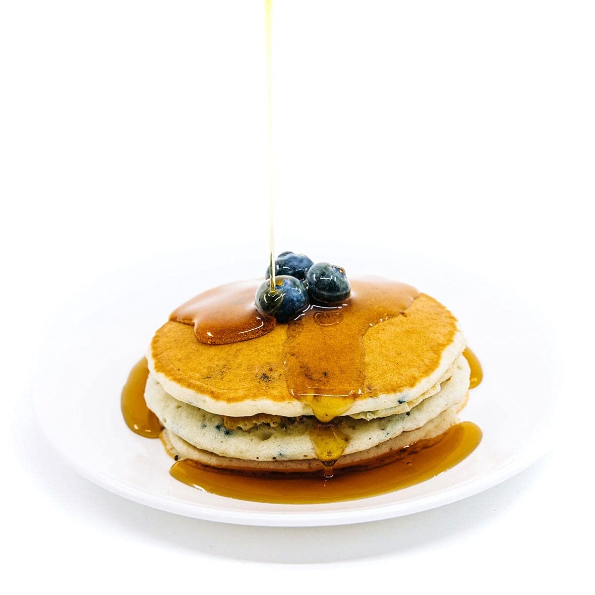 WonderSlim cooked pancakes plated with syrup and berries