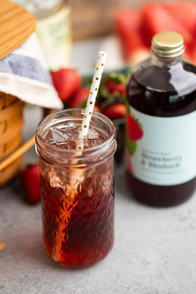 Wood Stove Kitchen Strawberry & Rhubarb Mix glass cocktail ready to enjoy.