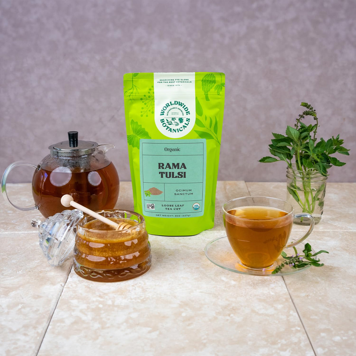 Pour-over cup of tulsi tea glowing amber, soothing aroma.