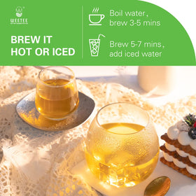 Dried WT WEETEE organic decaf green tea leaves under natural light.