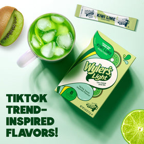 Wyler's Light kiwi lime packets dissolving in a glass for a bright drink.