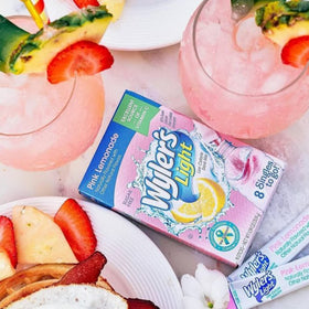 Wyler's Light pink lemonade packaging beside a water bottle.