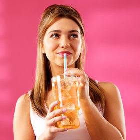 Wyler's Light Watertok Peach Ring mixed in water with a vibrant pink hue.