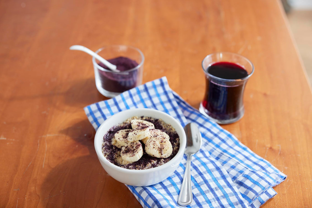 Wyman’s Wild Blueberry Powder is poured into a cup for a smoothie.