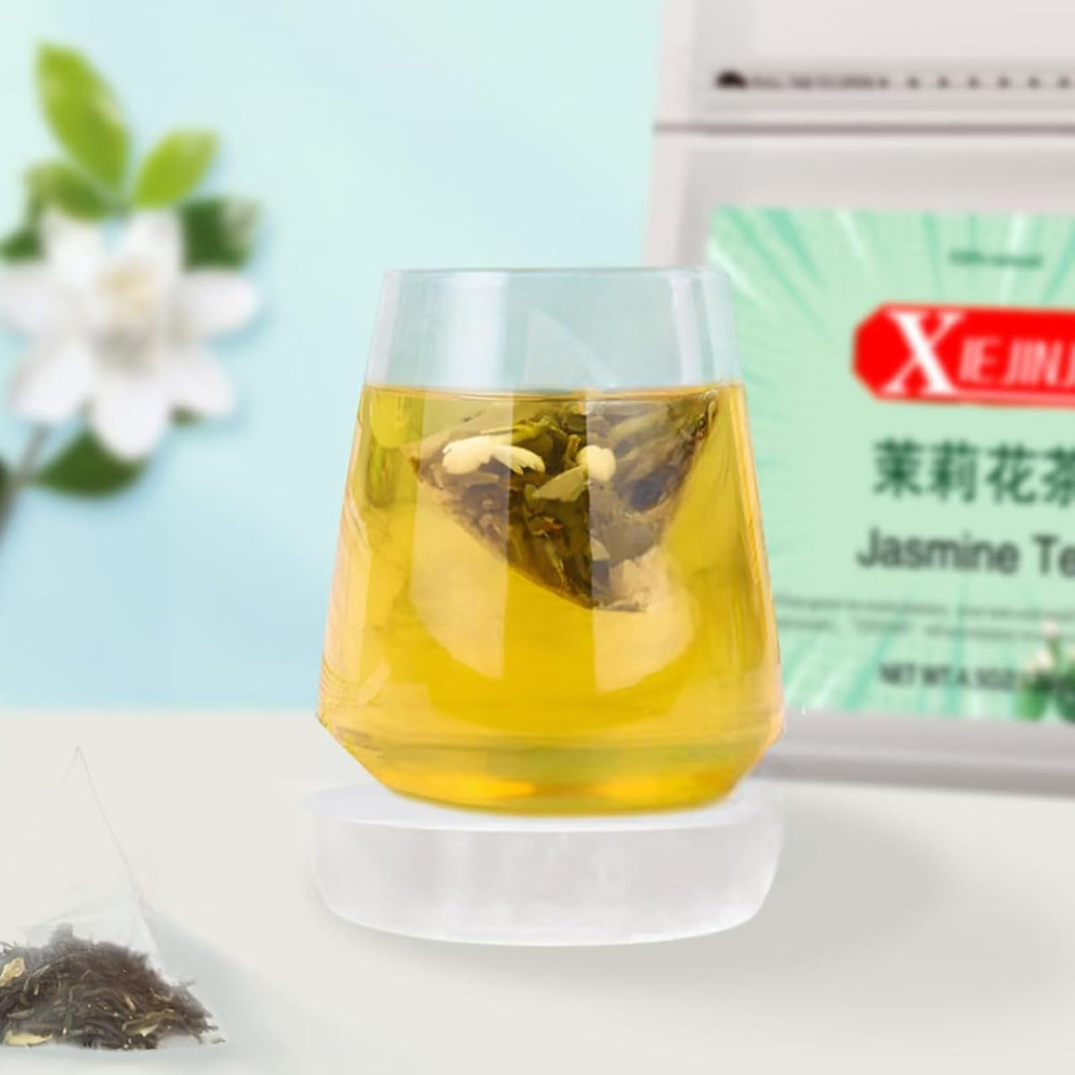 XIEJINJI Jasmine tea flowers and green tea closeup releasing fragrant aroma.
