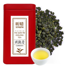 Xin Qing Tieguanyin tea leaves on a wooden tray, ready for infusion.