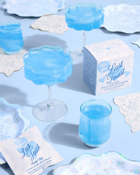 xo Fetti bridal shower toasts with blue glitter bombs adding color to drinks