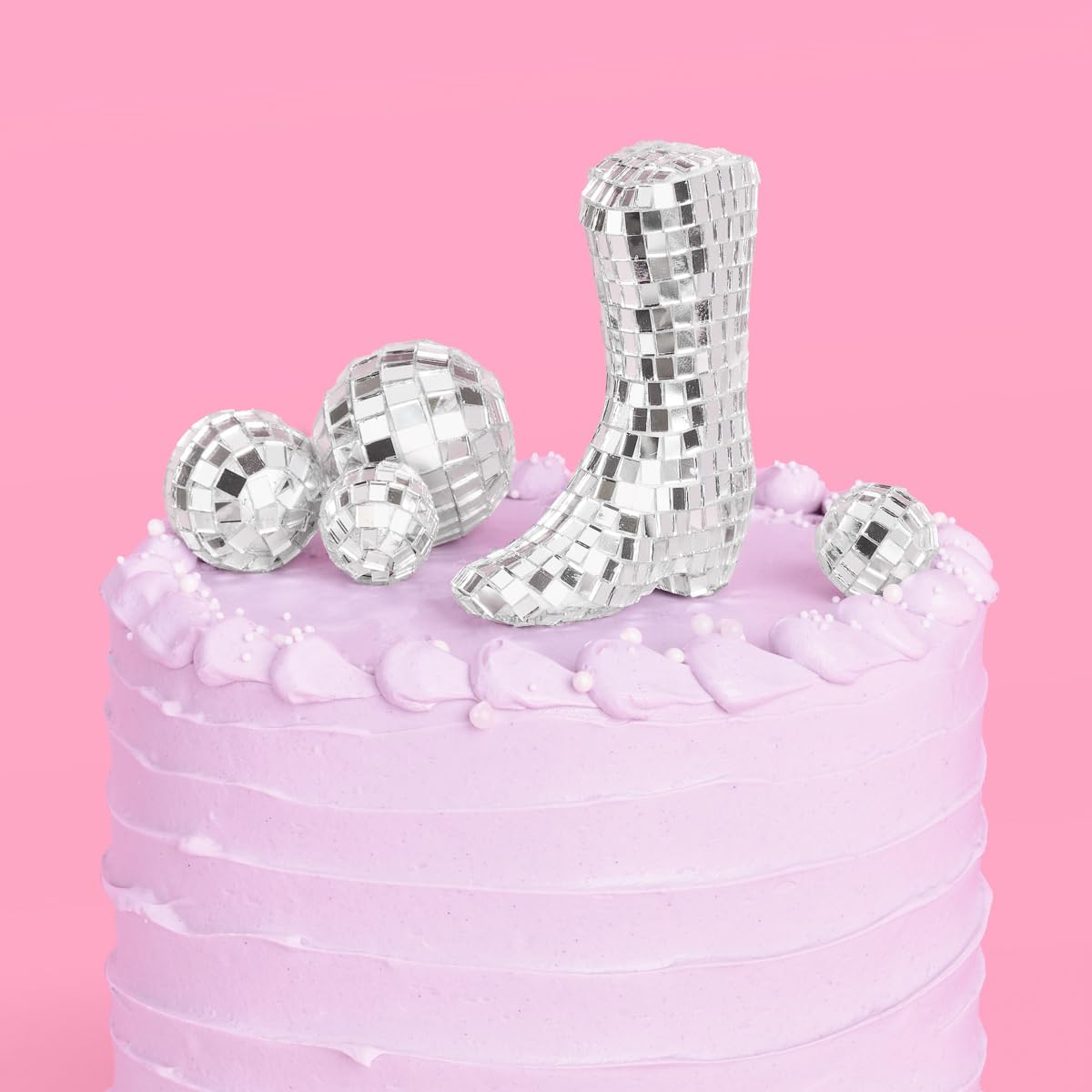 xo Fetti disco ball cowgirl boot topper adds glam to celebration cake.