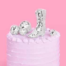 xo Fetti disco ball cowgirl boot topper adds glam to celebration cake.