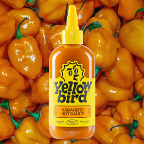 Yellowbird ingredients scene—carrots, garlic, tangerines add depth.