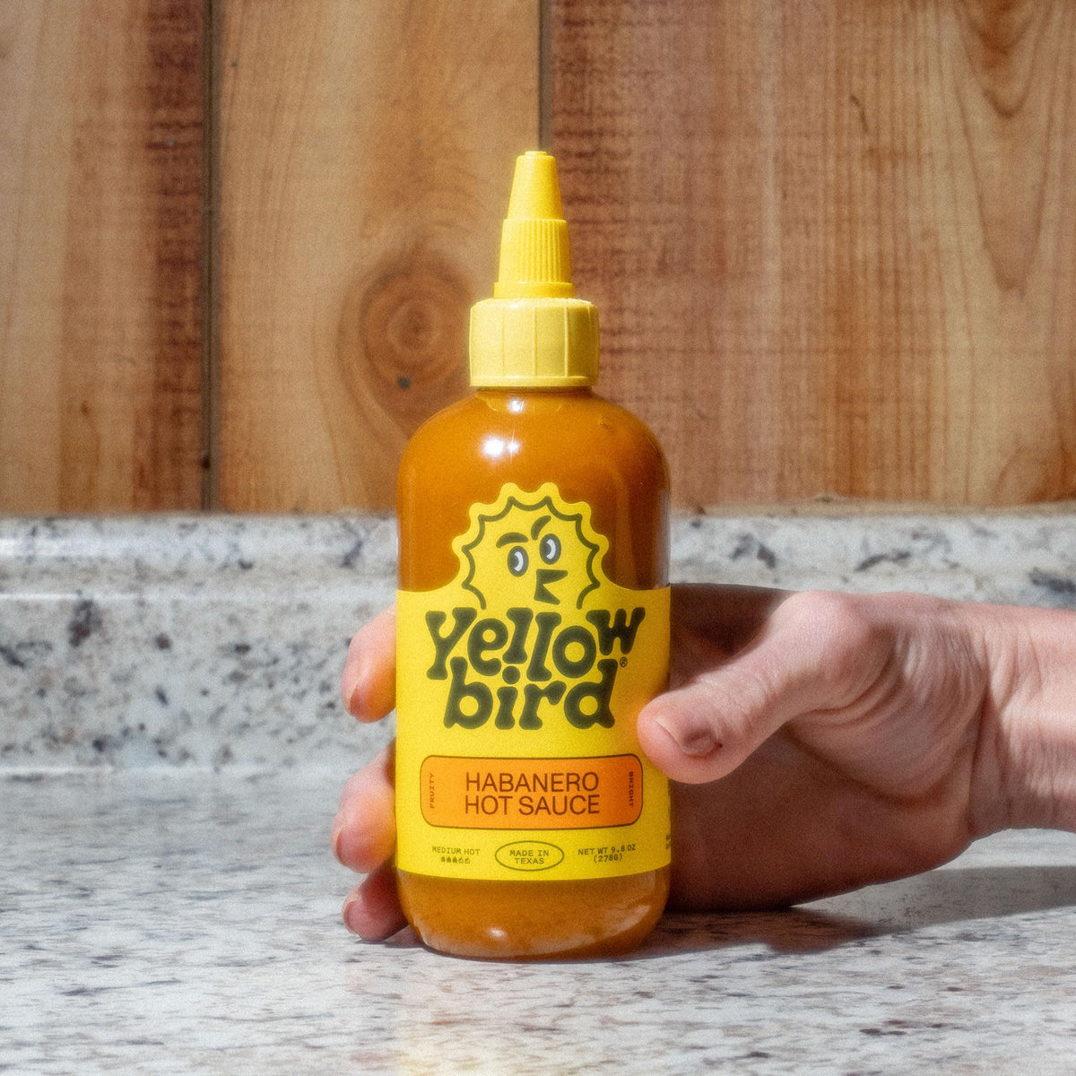 Yellowbird label close-up—bold tropical notes brighten dishes.