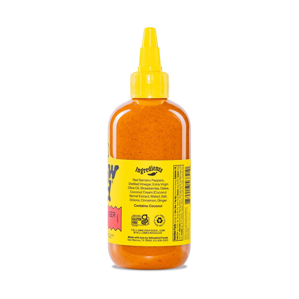 Texas-made Yellowbird sauce bottle on wooden board