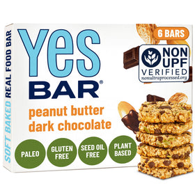 The YES Bar peanut butter dark chocolate bar close-up shows soft, chewy texture for snacking.