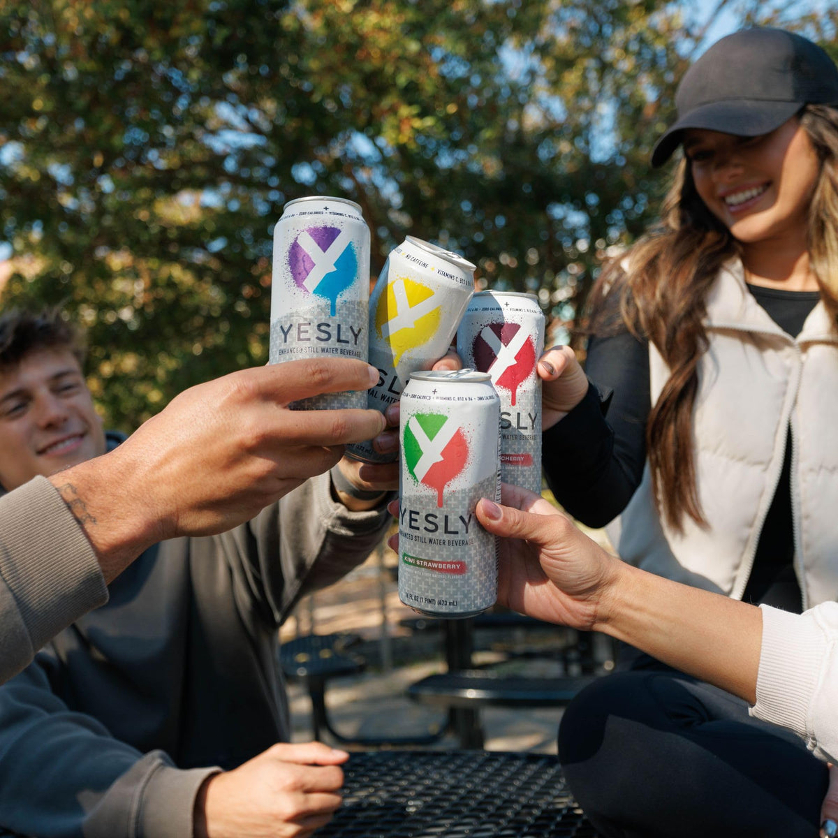 Yesly on-the-go scene beside a laptop suggests convenient hydration