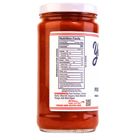 Yo Mama's Foods Keto Classic Pizza Sauce ingredients scene with whole tomatoes and garlic.