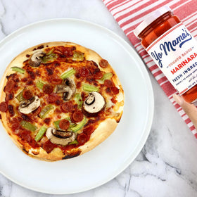 Pizza topped with Yo Mama’s Keto Marinara, showcasing a gluten-free, low-sugar sauce