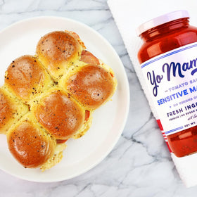 Yo Mama’s Sensitive Marinara being poured over al dente pasta for gluten-free dinner ideas.