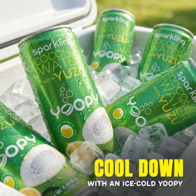 Yoopy Sparkling Coconut Water with Yuzu can held for on-the-go refreshment.