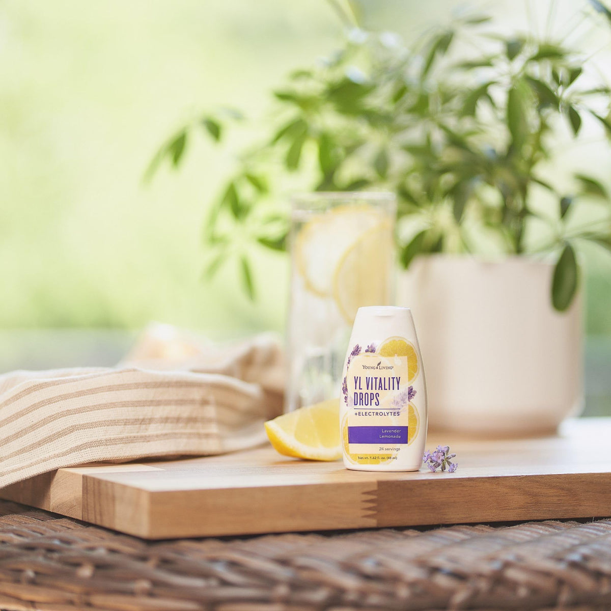 Liquid drops dispensing into water from Young Living YL Vitality Drops