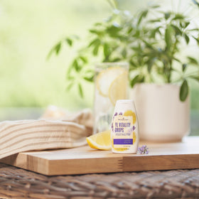Liquid drops dispensing into water from Young Living YL Vitality Drops