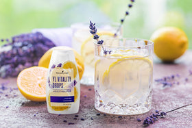 Pouring Young Living YL Vitality Drops Lavender Lemonade into a glass for flavor