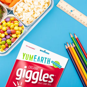YumEarth Giggles party snack bowl filled with colorful bites.