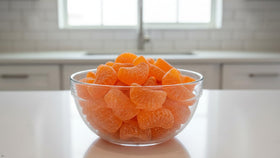 Yummy Chew orange slices candy party platter highlights vibrant citrus wedges.