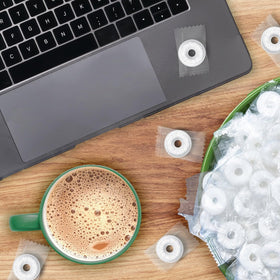 YUMTOV Wint-O-Green mints arranged in a bowl on a desk for office breaks.
