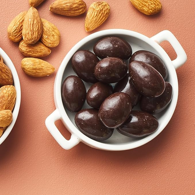 Yupik almonds in dark chocolate dipping detail highlights gourmet treat appeal