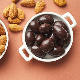 Yupik almonds in dark chocolate dipping detail highlights gourmet treat appeal