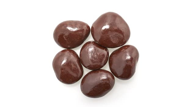 Yupik chocolate-covered cherries on a wooden board, ideal topping for brownies or cookies.