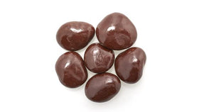 Yupik chocolate-covered cherries on a wooden board, ideal topping for brownies or cookies.