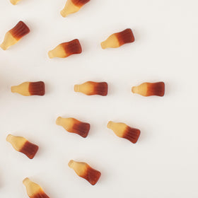 Yupik Gummy Cola Bottles in dish, perfect for parties and sharing.