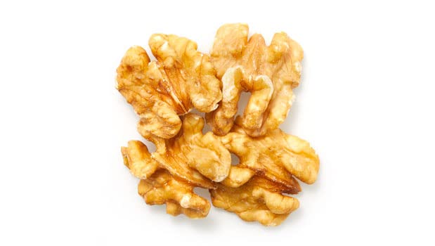Close-up of Yupik halved walnuts showing texture and richness.