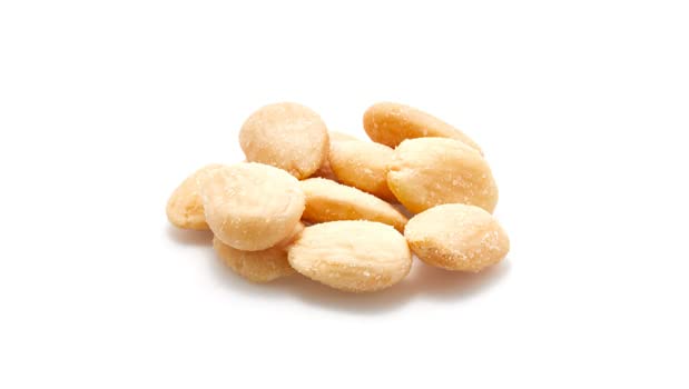 Skinless, blanched Yupik almonds showing creamy interior and uniform color.